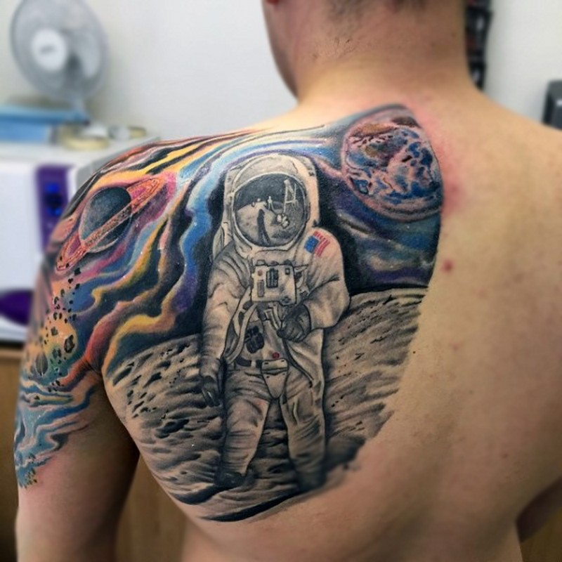 Accurate painted colored spaceman tattoo on shoulder