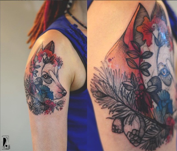 Accurate painted multicolored wolf tattoo by Joanna Swirska on upper arm