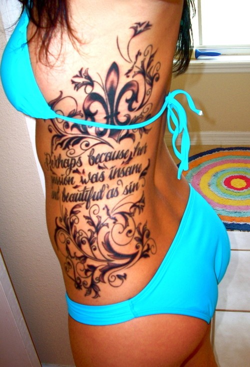 Adorable black fleur de lis with pattern and inscription tattoo on ribs for girls