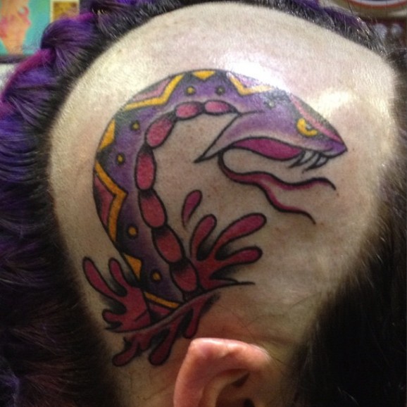 Aggressive purple snake on head tattoo