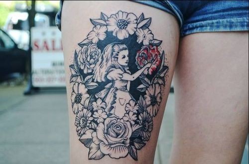 Alice in wonderland tattoo on hip