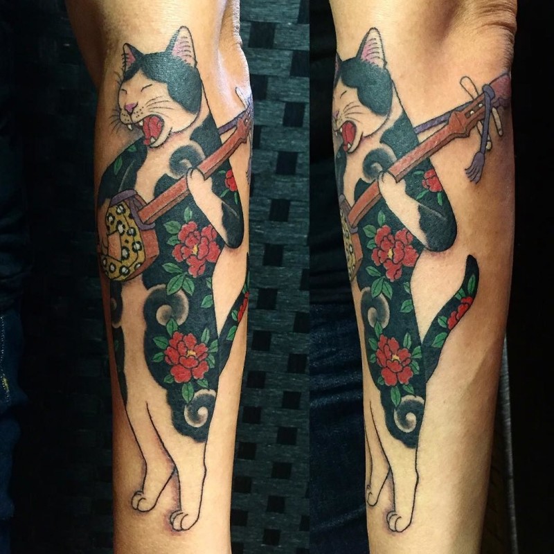 Amazing colored by horitomo forearm tattoo of Manmon cat musician