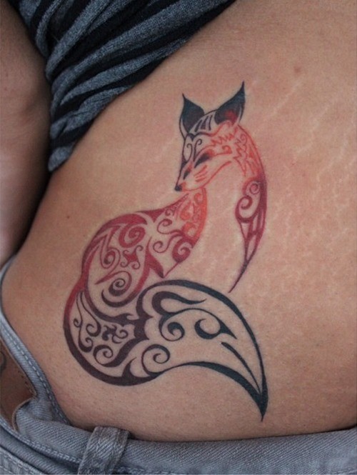Amazing colored little fox tattoo on waist stylized with tribal ornaments