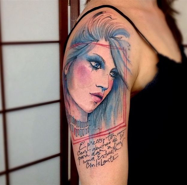 Amazing colored shoulder tattoo of woman portrait with lettering