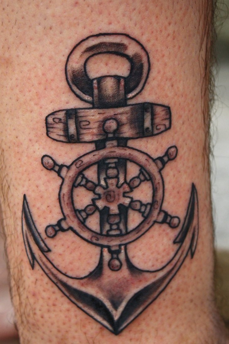 Amazing gray-ink anchor with wheel tattoo for guys on forearm