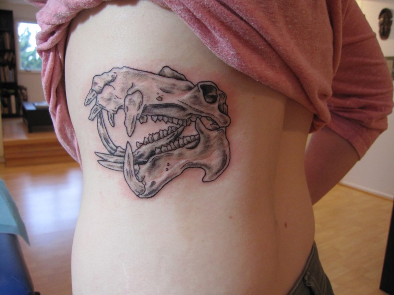 Amazing gray-ink hippo skull tattoo on side