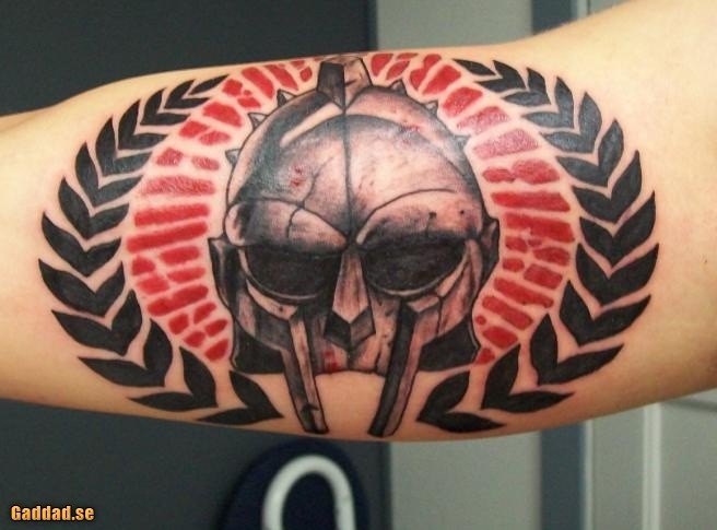 Amazing looking colored biceps tattoo of gladiators helmet with ornaments