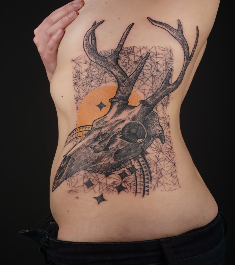 Amazing looking colored side tattoo of deers skull with various ornaments