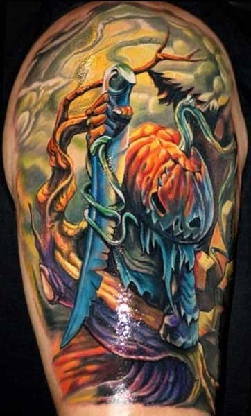 Amazing multicolored horror movie pumpkin with big knife tattoo on shoulder