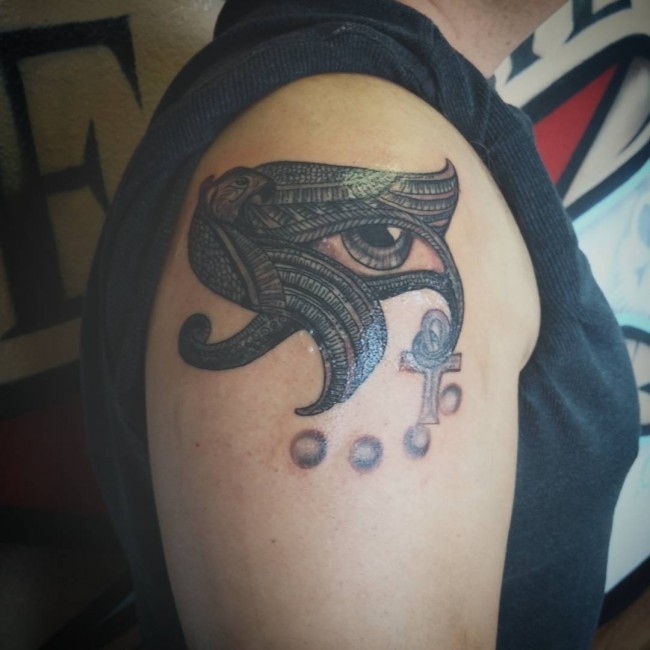 Amazing painted colored shoulder tattoo of Egypt themed eagle with Eye of Horus symbols