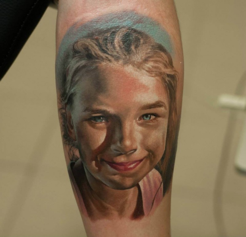 Amazing real photo like colorful forearm tattoo of smiling girl portrait