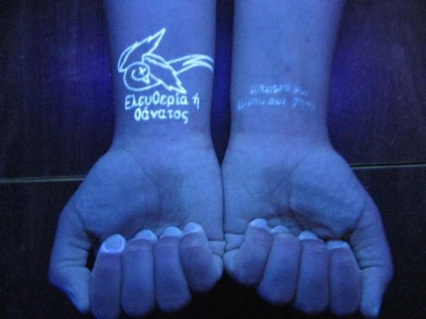 Amazing scripts on wrist black light style tattoo