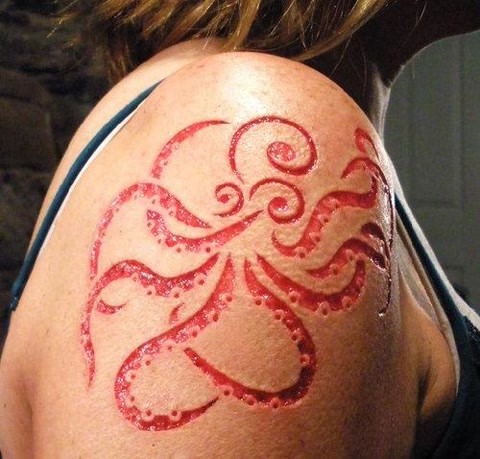 Amazing skin scarification octopus on shoulder