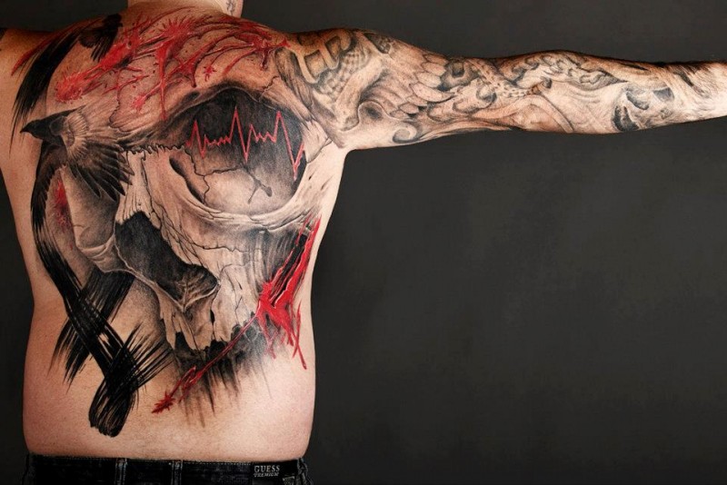 Amazing skull trash polka tattoo on back