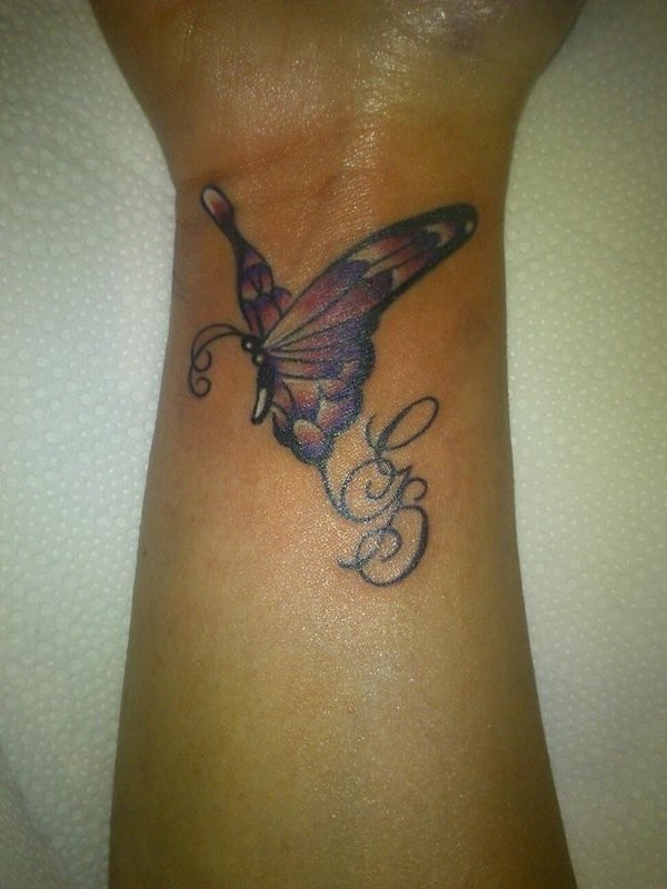 Amazing small butterfly tattoo on wrist with lettering