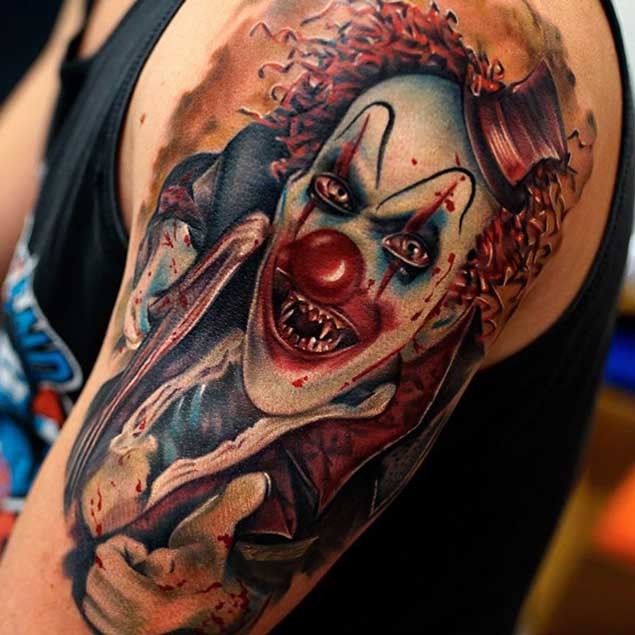 Amazing very detailed colored evil clown tattoo on shoulder