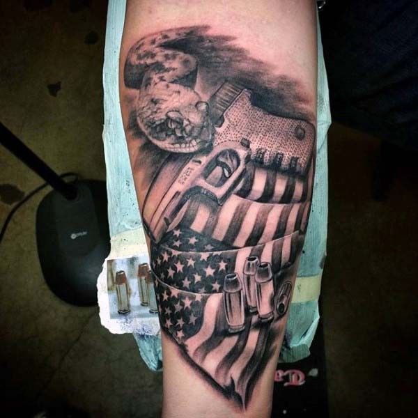 American native black and white pistol with flag and bullets tattoo on arm