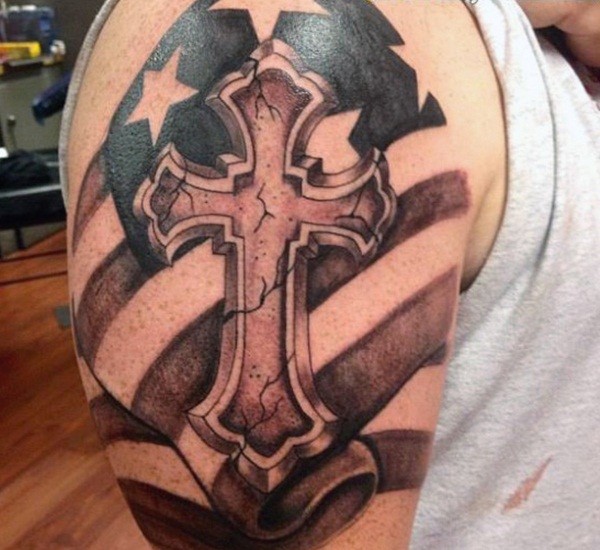 American native colored antic cross tattoo on shoulder with old flag