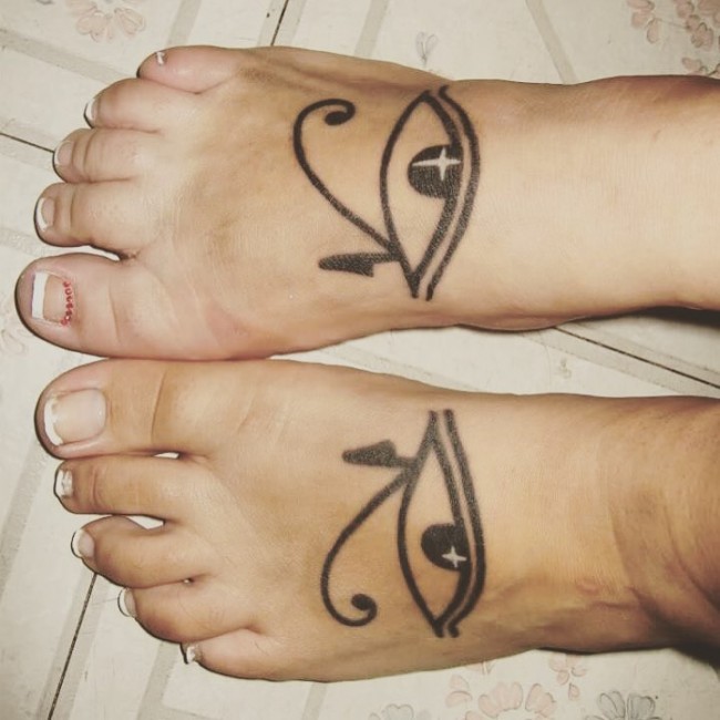 Ancient Egyptian symbol the Eye of Horus tattoo with sparkles on both foot