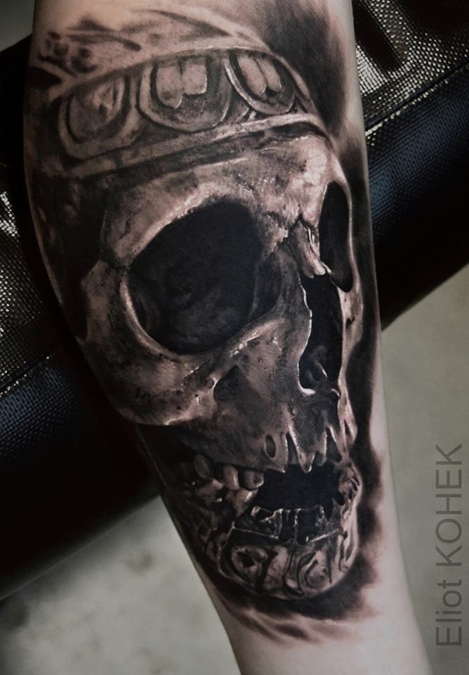 Ancient like detailed leg tattoo of human skull stylized with ornaments by Eliot Kohek