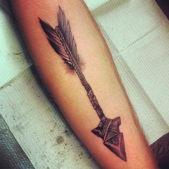 Ancient tribal arrow tattoo design