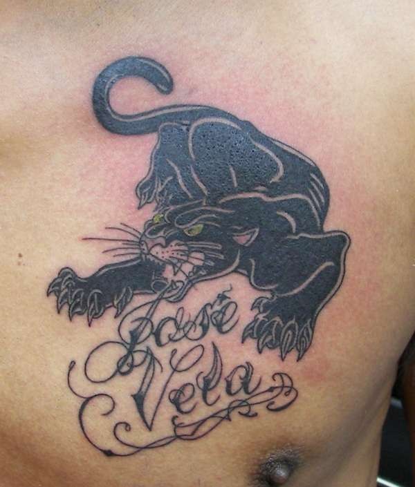 Angry black panther and inscription tattoo on chest