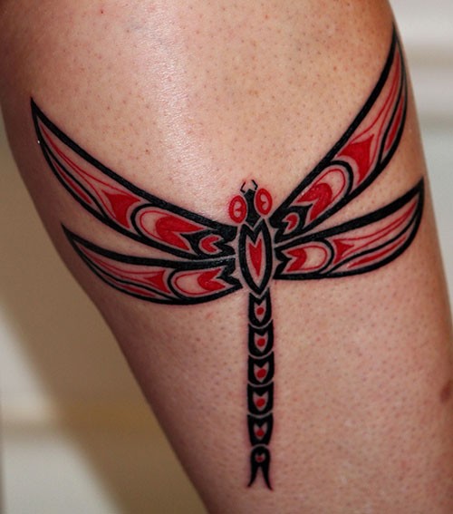 Angry dragonfly tattoo on leg