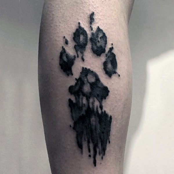 Animal paw print black ink watercolor tattoo with paint drips
