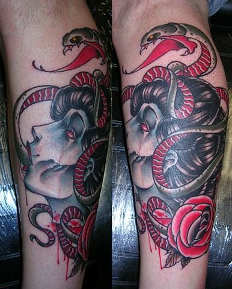 Antic multicolored leg tattoo of Medusa severed head with snakes