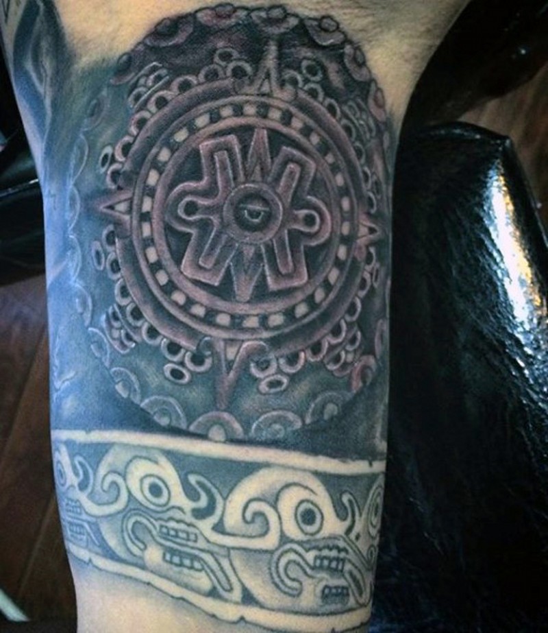 Antic tribes detailed tablet tattoo on arm