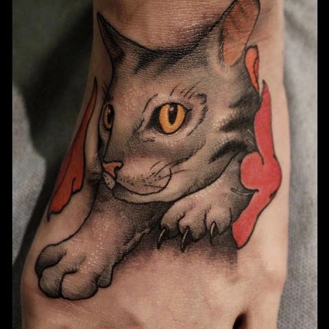 Art style colored foot tattoo of small cowling cat