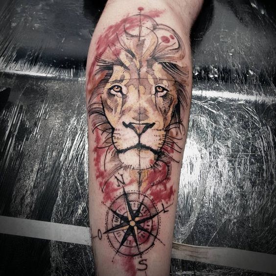 Art style colored leg tattoo of cool lion with compass