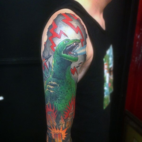 Asian cartoon like multicolored Godzilla sleeve area tattoo