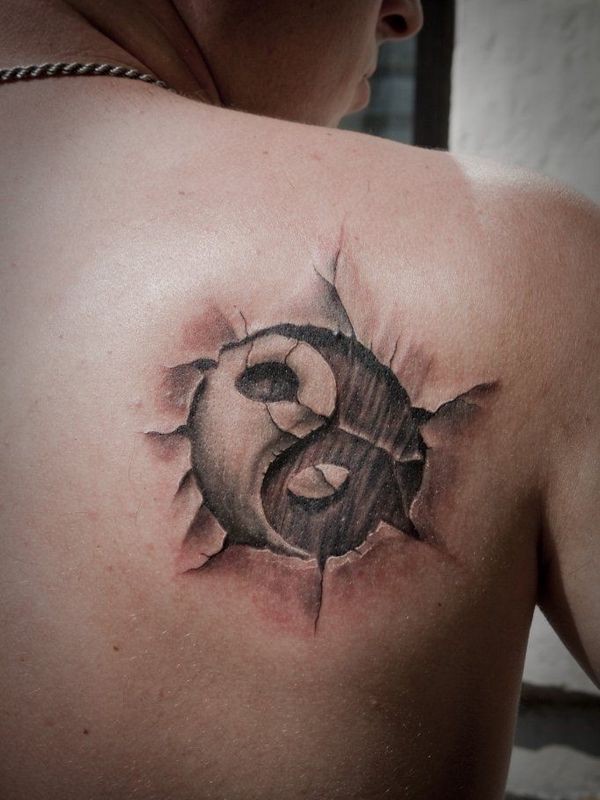 Asian faded Yin Yang special symbol into skin with cracks 3D realistic tattoo on shoulder blade