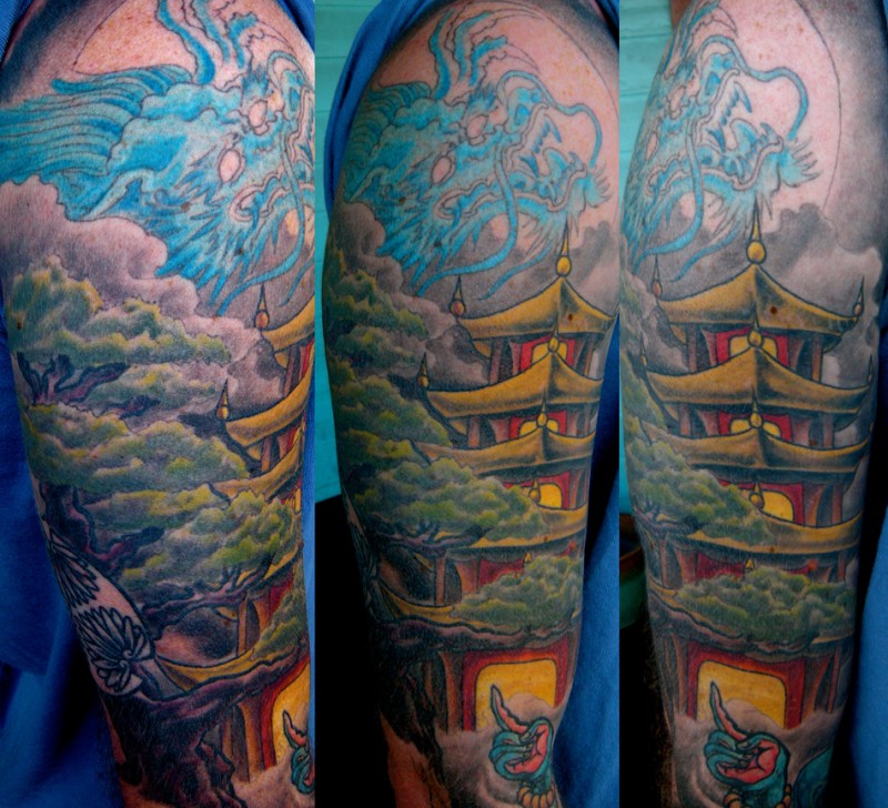 Asian native colorful shoulder tattoo of blue dragon and old temple