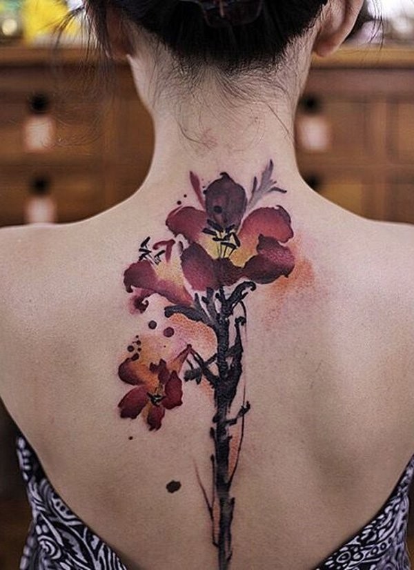 Asian style abstract painted colored big flowers tattoo on back stylized with symbol