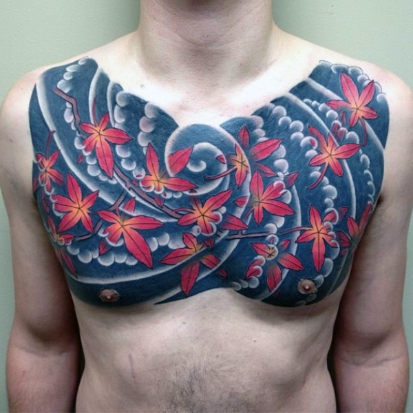 Asian style autumn colored leaves and waves chest tattoo