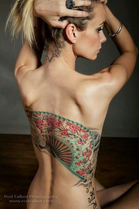 Tatuaje en la espalda, abanico hermoso multicolor con patrón floral
