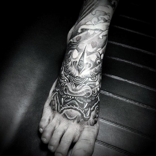 Asian style big detailed fantasy dragon tattoo on foot
