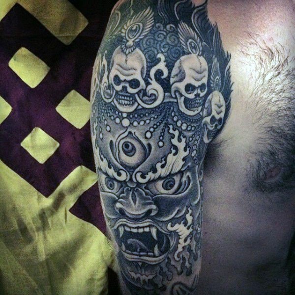 Asian style black and white demonic tiger tattoo on shoulder stylized with skulls