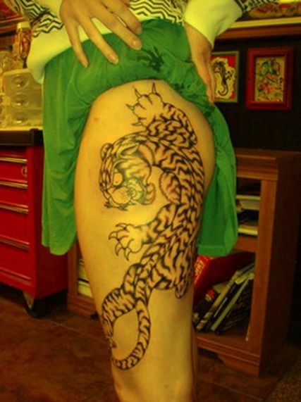 Asian style black and white little tiger tattoo on thigh