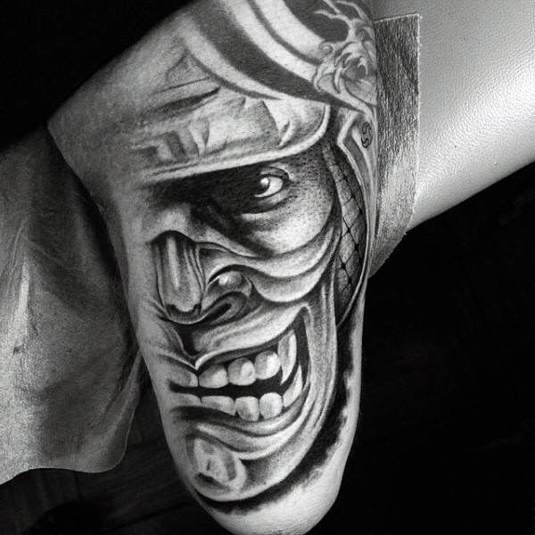 Asian style black and white samurai mask tattoo on arm