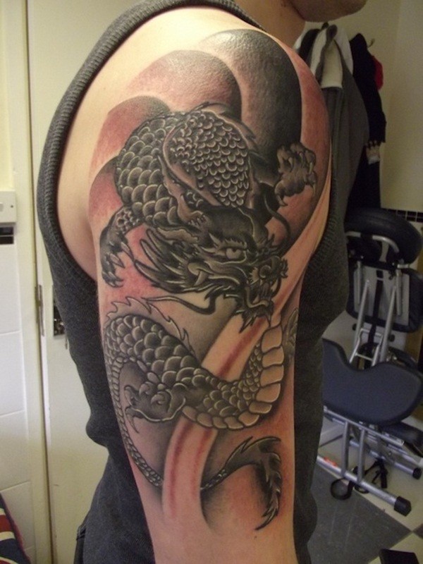 Asian style black and white shoulder tattoo of fantasy dragon
