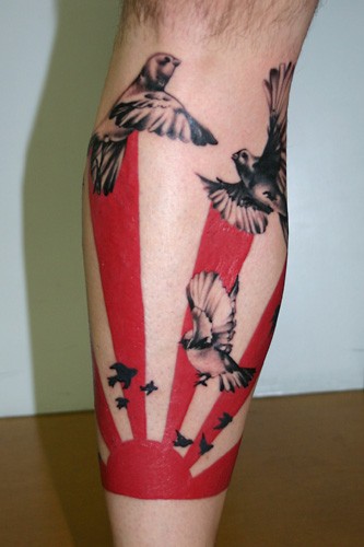Asian style colored leg tattoo of sun with flying birds