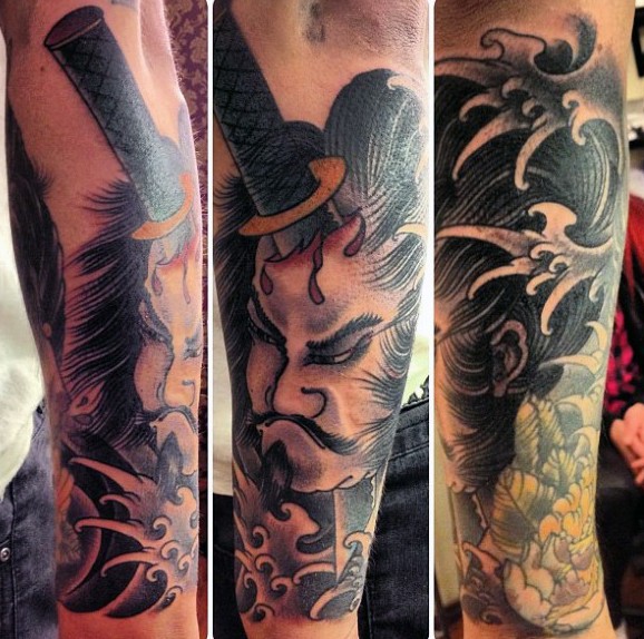 Asian style colored samurai warrior with sword in head tattoo on sleeve