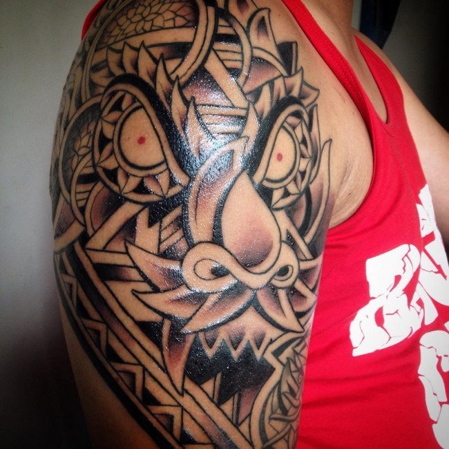 Asian style colored shoulder tattoo of big fantasy dragon head