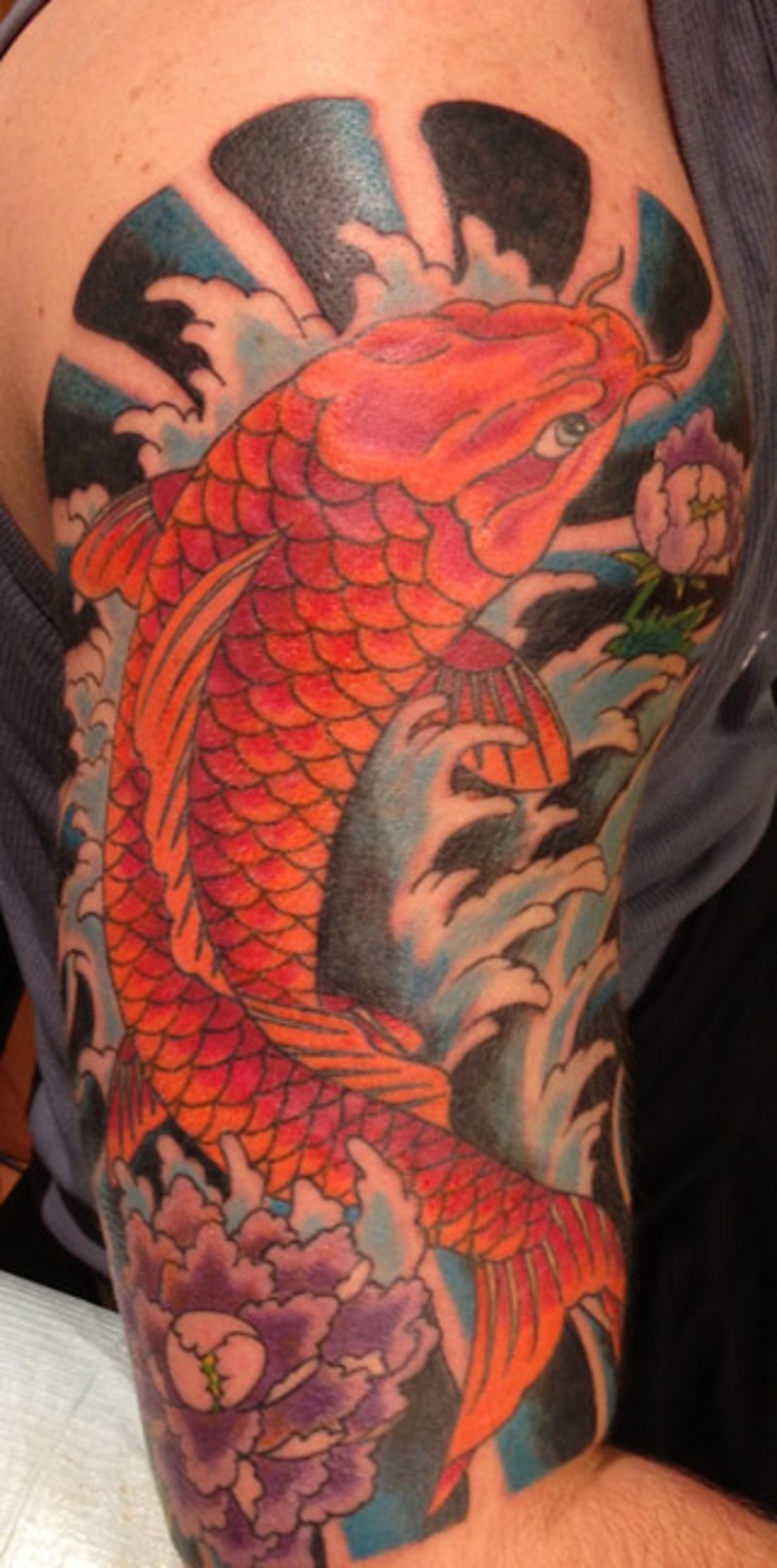Asian style colorful shoulder tattoo of carp fish flowers and waves