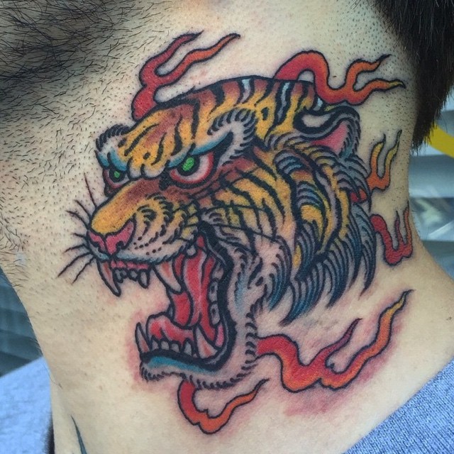 Asian style furious roaring tiger&quots head colored neck tattoo in fire flames