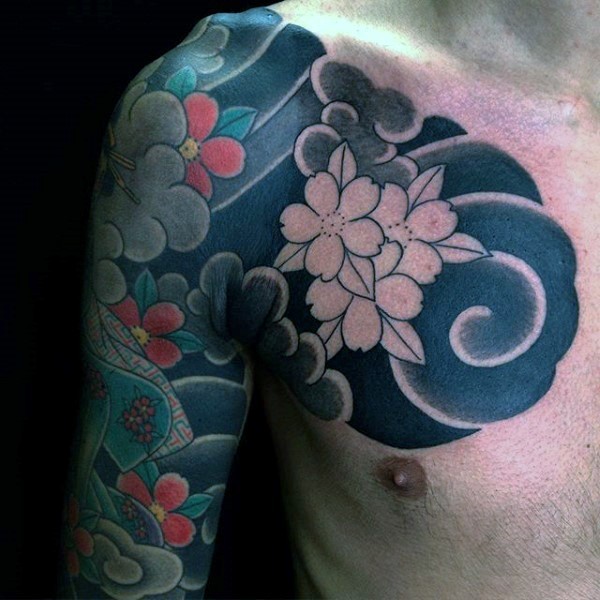 Asian style half colored on chest and shoulder tattoo of flowers