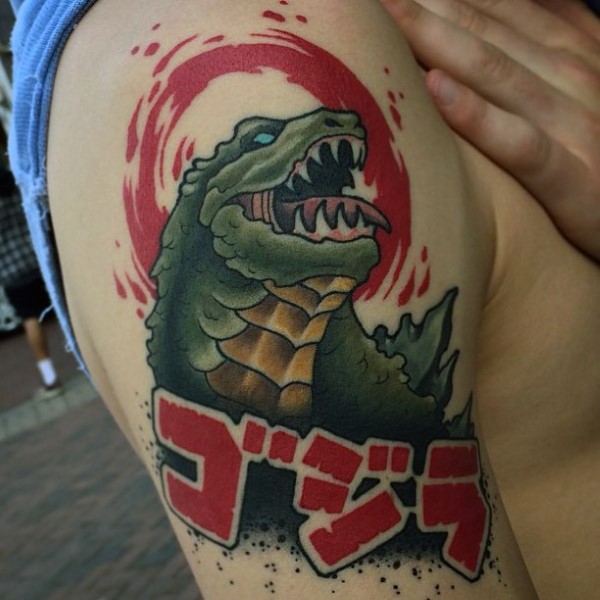Asian style multicolored Godzilla shoulder tattoo with lettering